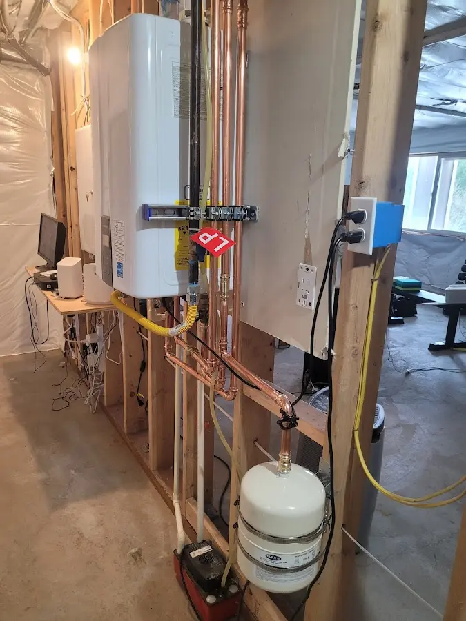 Licensed plumber repairing a kitchen sink in DeWitt